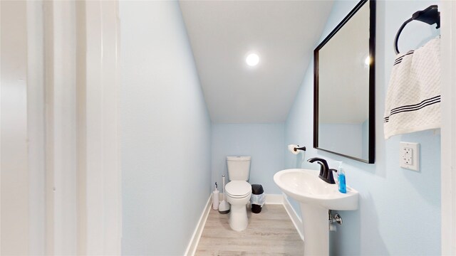 846 Alma, Crystal Beach, TX 77650 - bathroom with wood finished floors, toilet, and baseboards