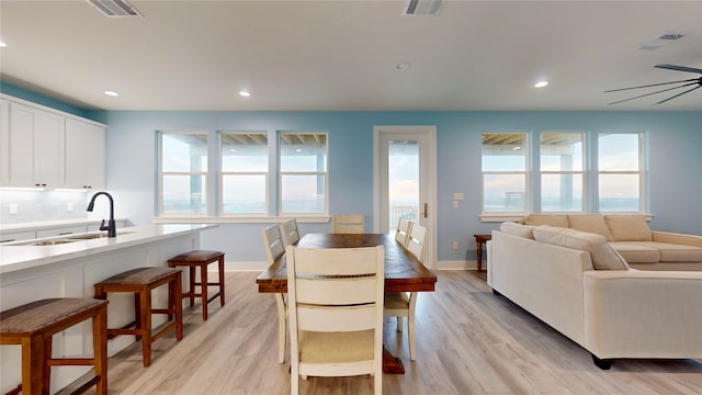 dining space featuring a wealth of natural light, ceiling fan, and light wood-type flooring