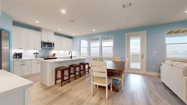 dining room featuring light hardwood / wood-style floors and sink