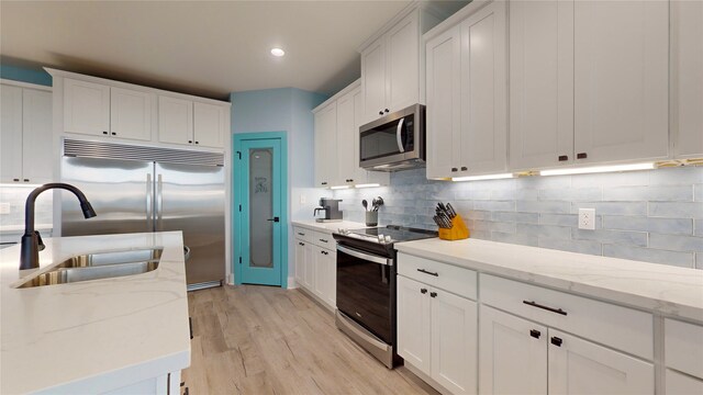 846 Alma, Crystal Beach, TX 77650 - kitchen with stainless steel appliances, a sink, white cabinetry, light wood finished floors, and recessed lighting