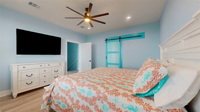 846 Alma, Crystal Beach, TX 77650 - bedroom with light wood finished floors, a barn door, recessed lighting, ceiling fan, and baseboards