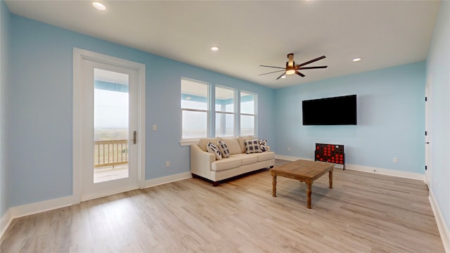 living room featuring light hardwood / wood-style floors and ceiling fan