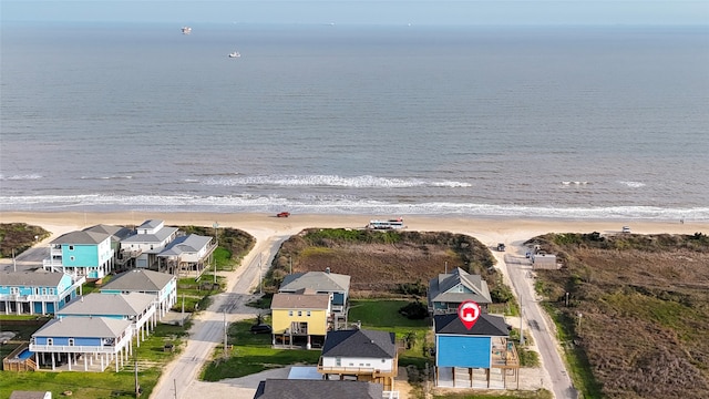 birds eye view of property with a beach view and a water view