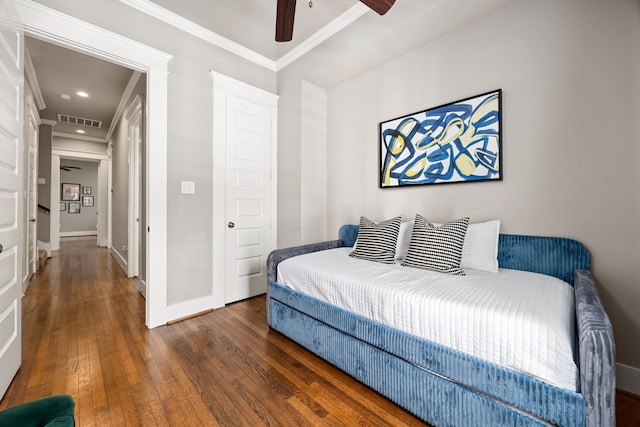 bedroom featuring ceiling fan, dark hardwood / wood-style floors, and ornamental molding