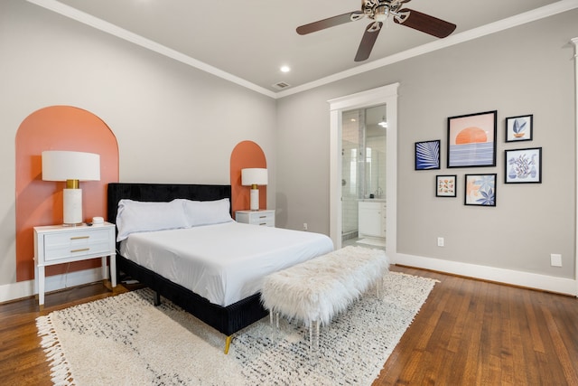 bedroom featuring ornamental molding, ensuite bath, ceiling fan, and dark hardwood / wood-style flooring