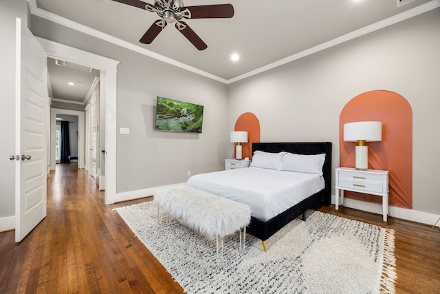 bedroom with wood-type flooring, crown molding, and ceiling fan