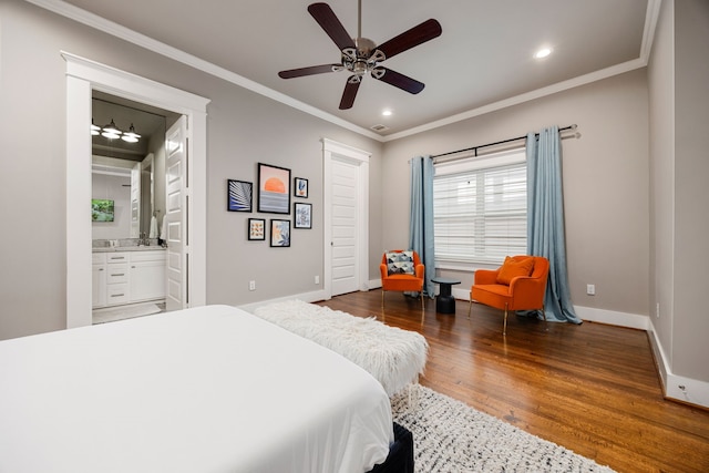 bedroom featuring ceiling fan, crown molding, ensuite bathroom, and dark hardwood / wood-style flooring