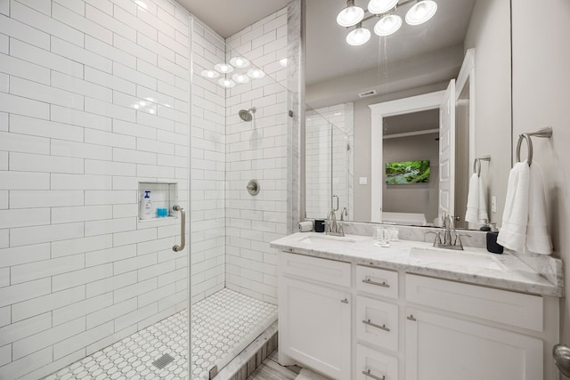 bathroom featuring vanity and a shower with shower door