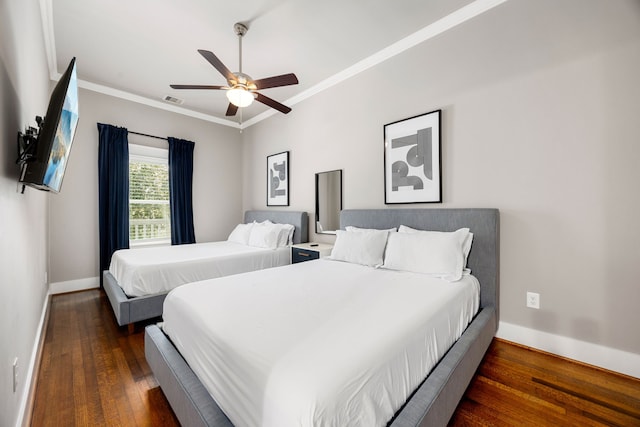 bedroom featuring ornamental molding, ceiling fan, and dark hardwood / wood-style flooring