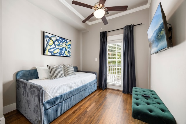 bedroom with ceiling fan, crown molding, and dark hardwood / wood-style flooring