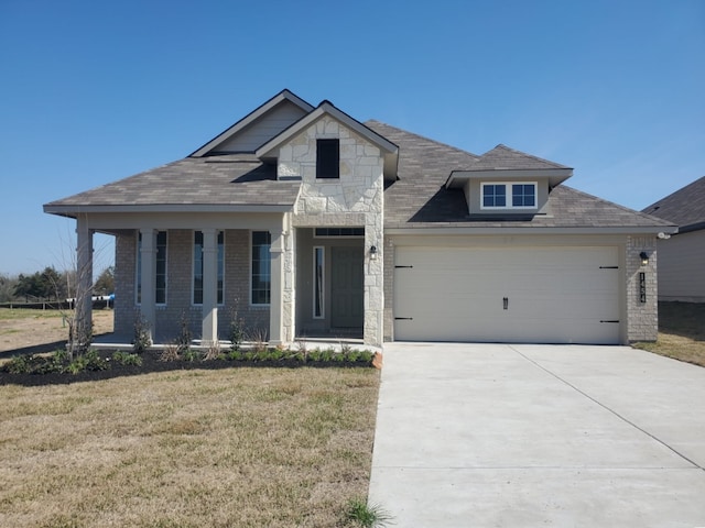 view of front facade featuring driveway, stone siding, a front lawn, and brick siding