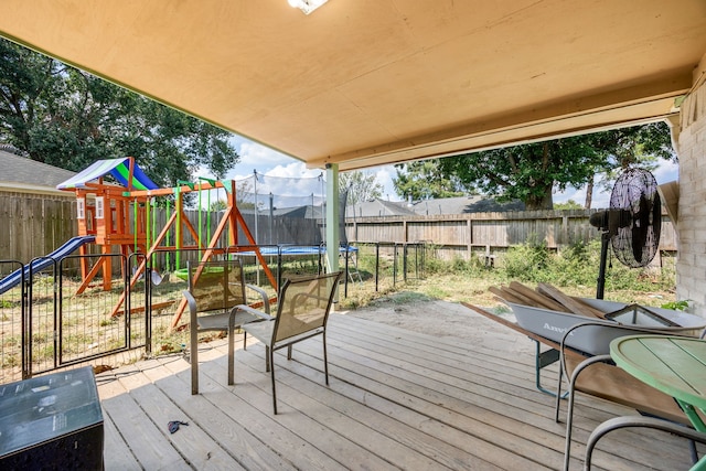 deck with a trampoline and a playground