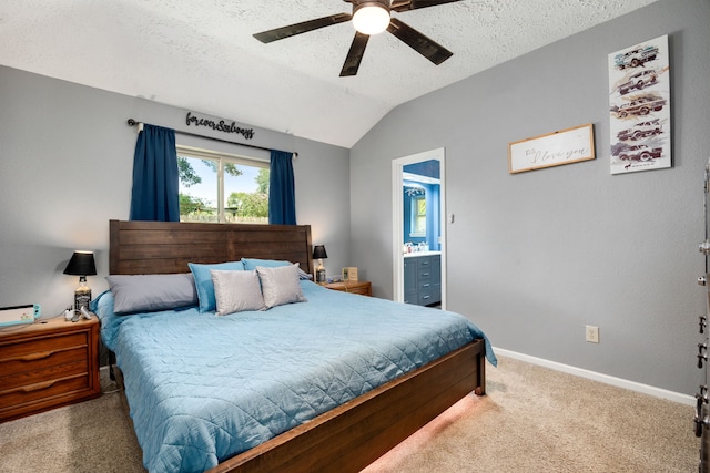 bedroom featuring carpet, connected bathroom, vaulted ceiling, and ceiling fan