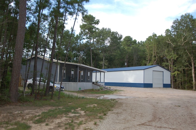 manufactured / mobile home featuring an outdoor structure and a garage