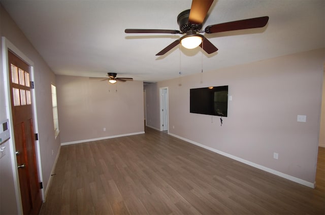 spare room with ceiling fan and dark hardwood / wood-style floors