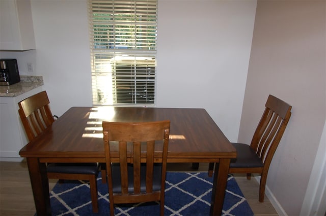 dining space with hardwood / wood-style floors