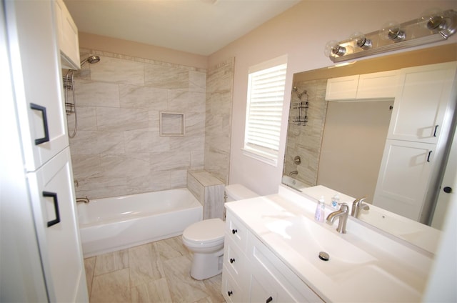 full bathroom with tiled shower / bath combo, vanity, and toilet