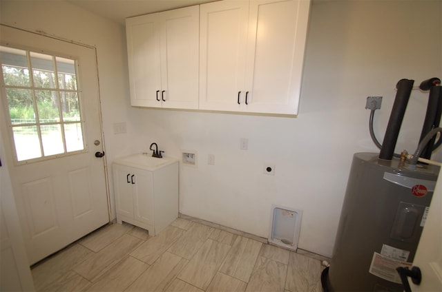 washroom with hookup for a washing machine, water heater, hookup for an electric dryer, cabinets, and sink