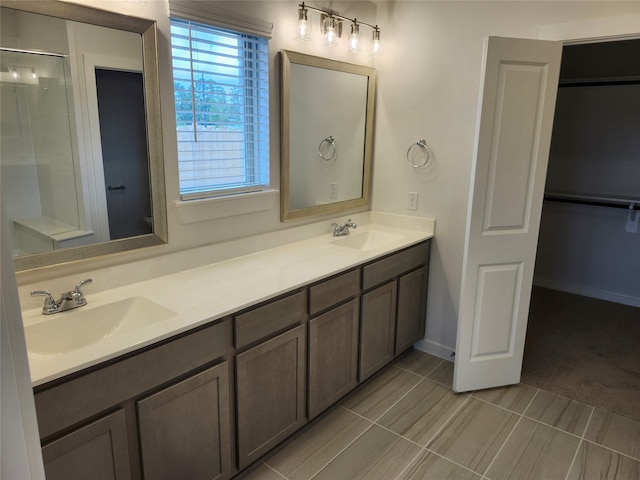 bathroom with walk in shower, vanity, and toilet