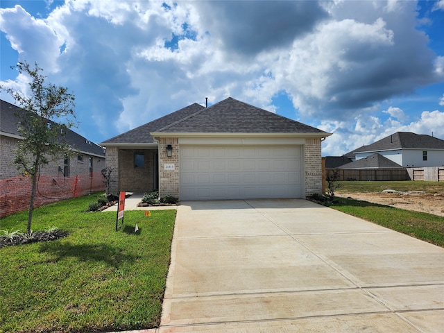 single story home featuring a garage and a front lawn