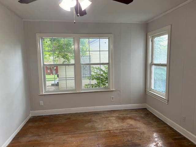 unfurnished room featuring crown molding, dark wood-type flooring, and ceiling fan