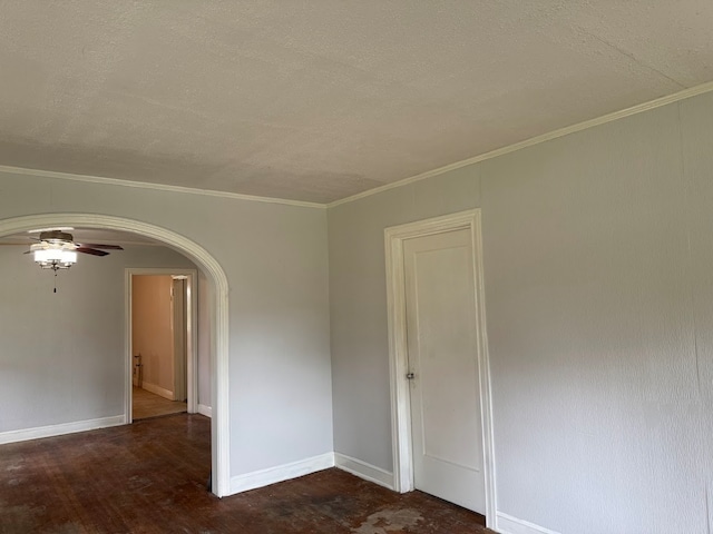 empty room featuring ceiling fan, ornamental molding, a textured ceiling, and dark hardwood / wood-style flooring