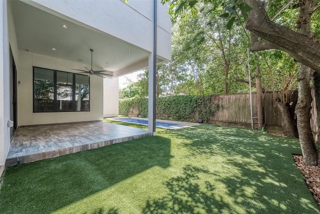 view of yard featuring ceiling fan and a patio area