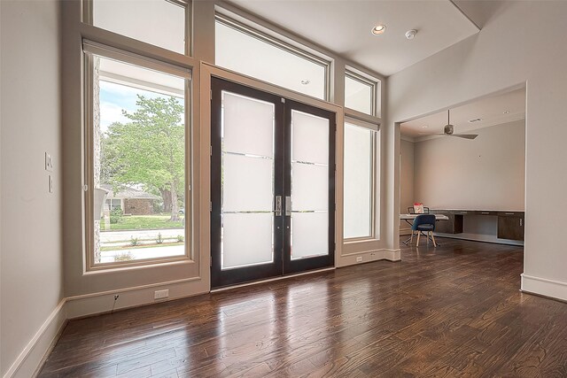 entryway with a healthy amount of sunlight, dark hardwood / wood-style floors, and french doors