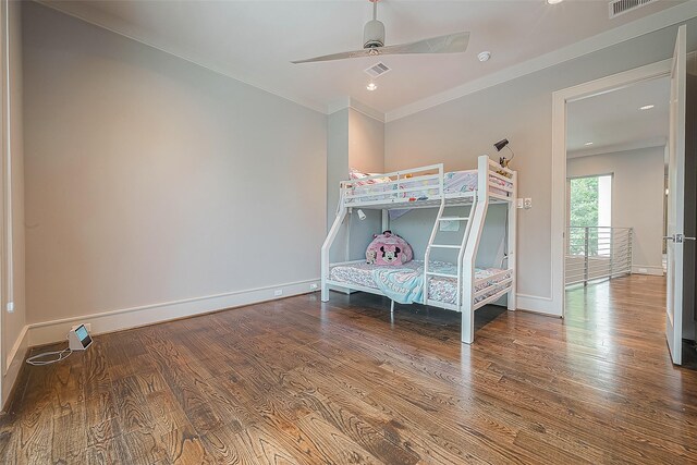 unfurnished bedroom with ceiling fan, crown molding, and wood-type flooring