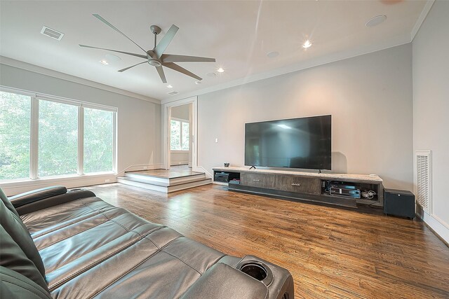 living room with ornamental molding, hardwood / wood-style floors, and ceiling fan