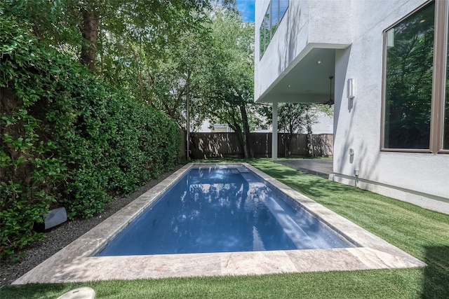 view of pool featuring a yard