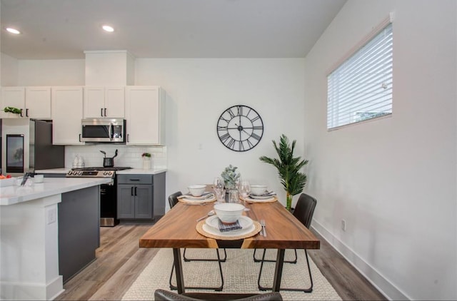 dining area featuring light wood-type flooring