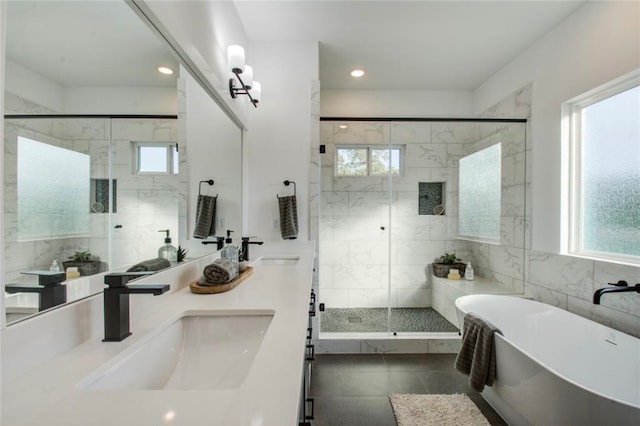 bathroom with tile walls, tile patterned flooring, vanity, and plus walk in shower