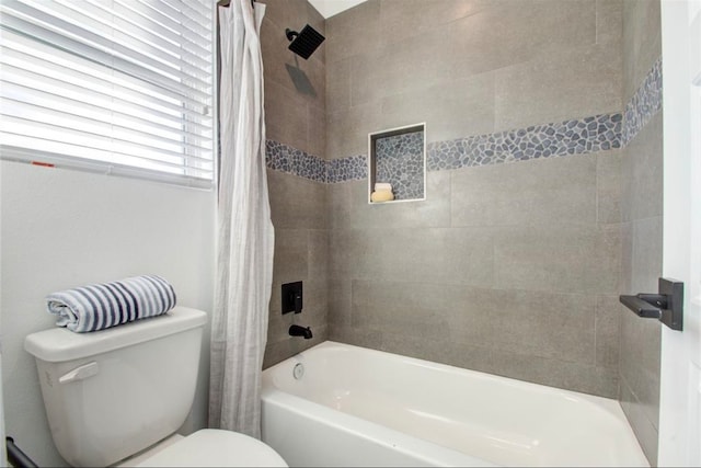 bathroom featuring shower / bathtub combination with curtain and toilet