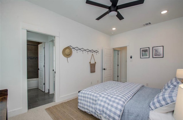 bedroom featuring carpet floors, connected bathroom, and ceiling fan