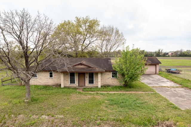 single story home with a front yard and a garage