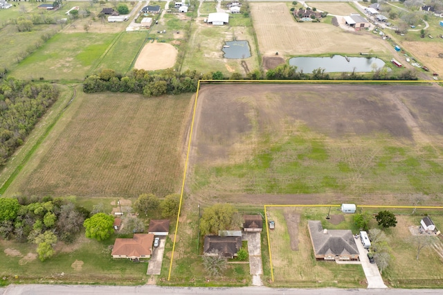 drone / aerial view featuring a water view and a rural view