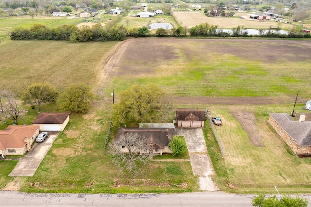 drone / aerial view featuring a water view and a rural view