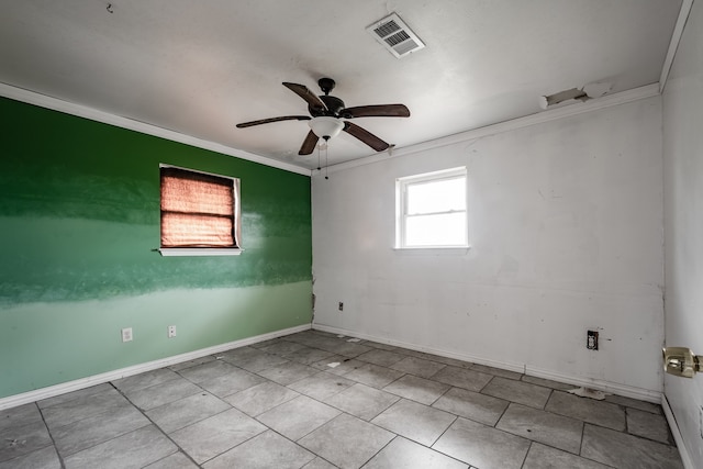 spare room with ceiling fan, a healthy amount of sunlight, and crown molding