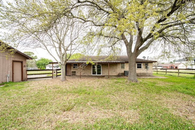 rear view of house featuring a yard