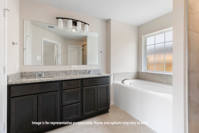 bathroom with vanity, a bath, and tile patterned floors