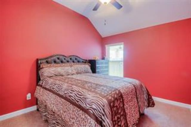 bedroom featuring ceiling fan, light colored carpet, and lofted ceiling