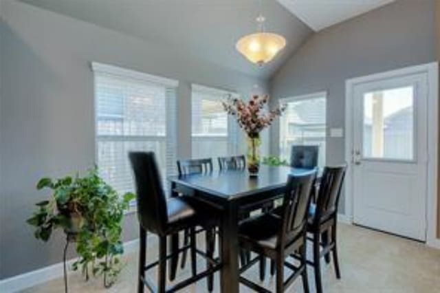 dining area featuring lofted ceiling