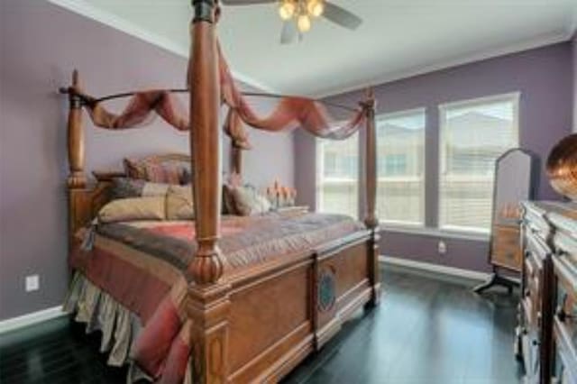 bedroom with ceiling fan, dark wood-type flooring, and ornamental molding