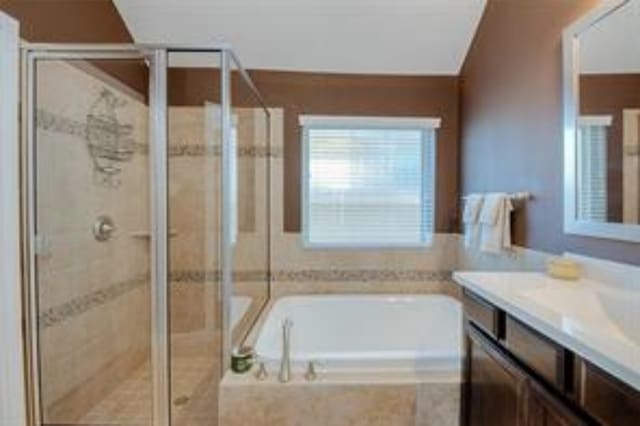 bathroom with shower with separate bathtub, lofted ceiling, and vanity