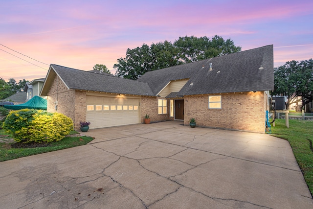 view of property featuring a lawn and a garage