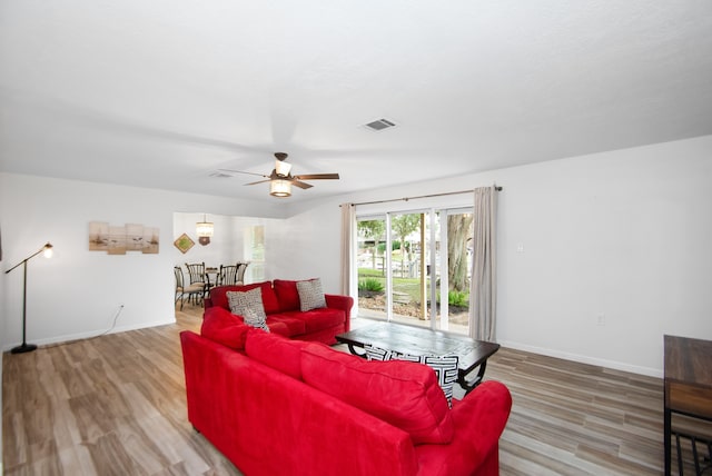 living room featuring wood-type flooring and ceiling fan