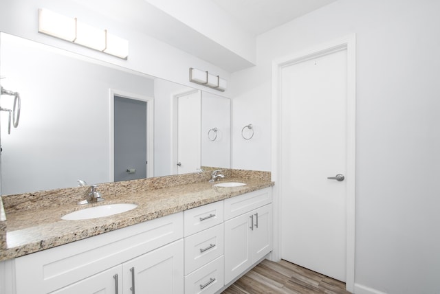 bathroom with hardwood / wood-style floors and vanity