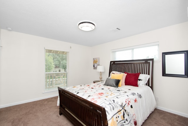 bedroom featuring light carpet