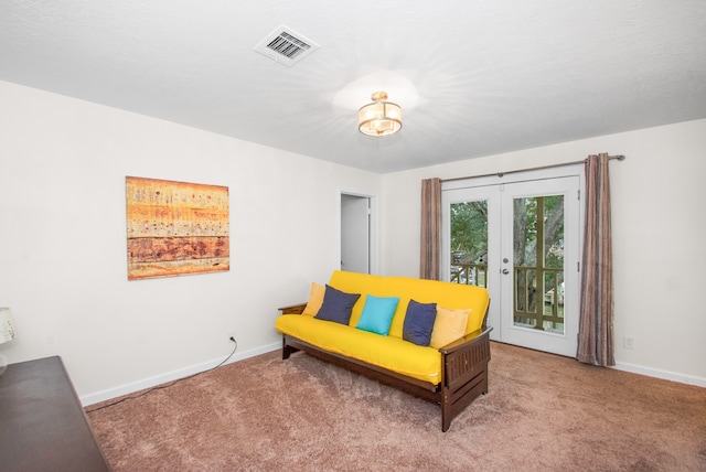 living area with carpet flooring and french doors